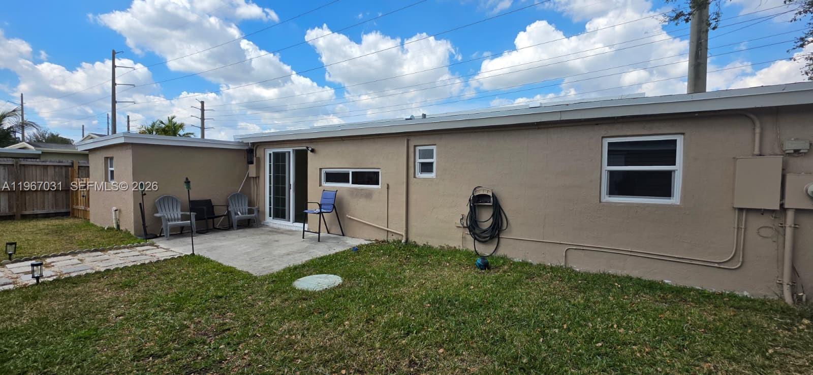 5900 Atlanta Street Hollywood, FL 33021 - Photo 19 of 21 a backyard of a house with yard fire pit and chairs