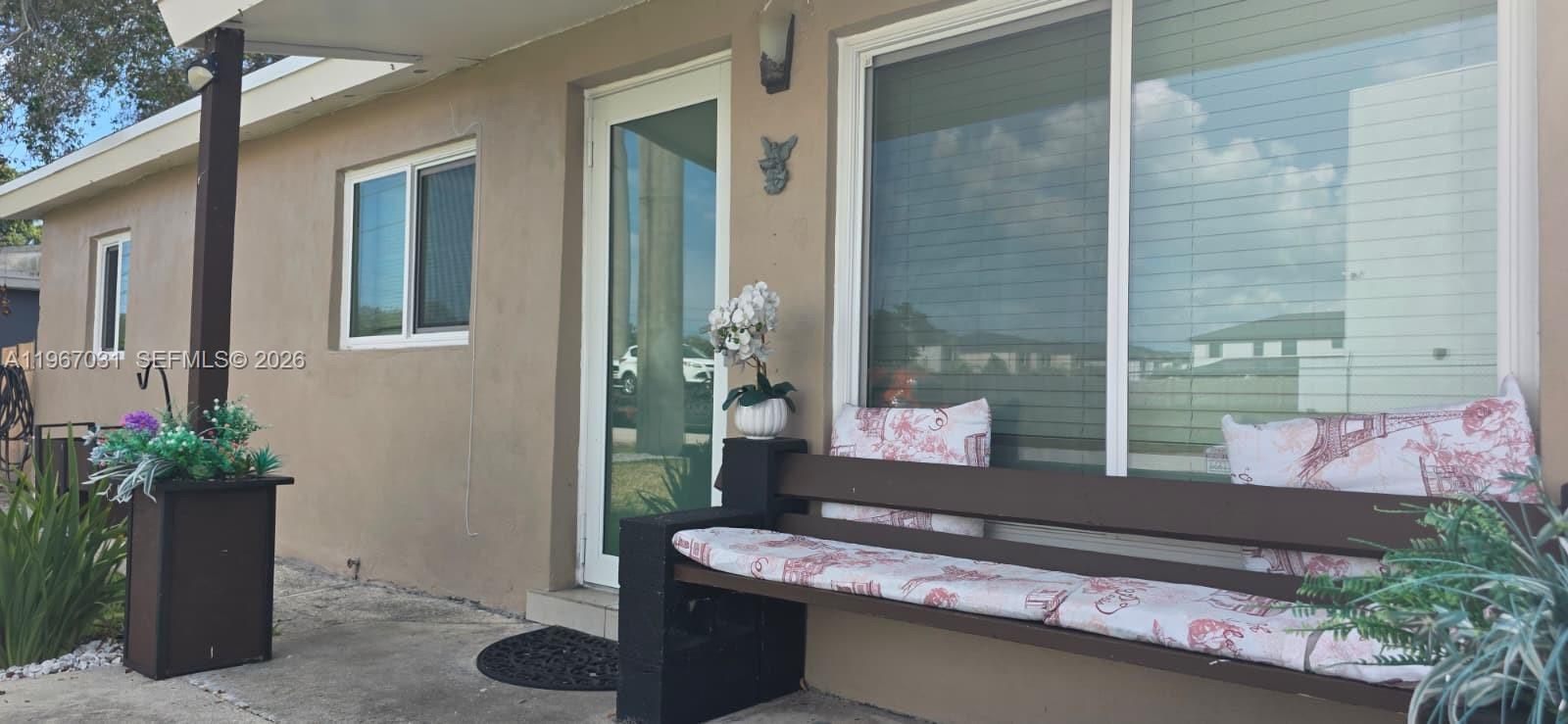 5900 Atlanta Street Hollywood, FL 33021 - Photo 2 of 21 a room with furniture and potted plants