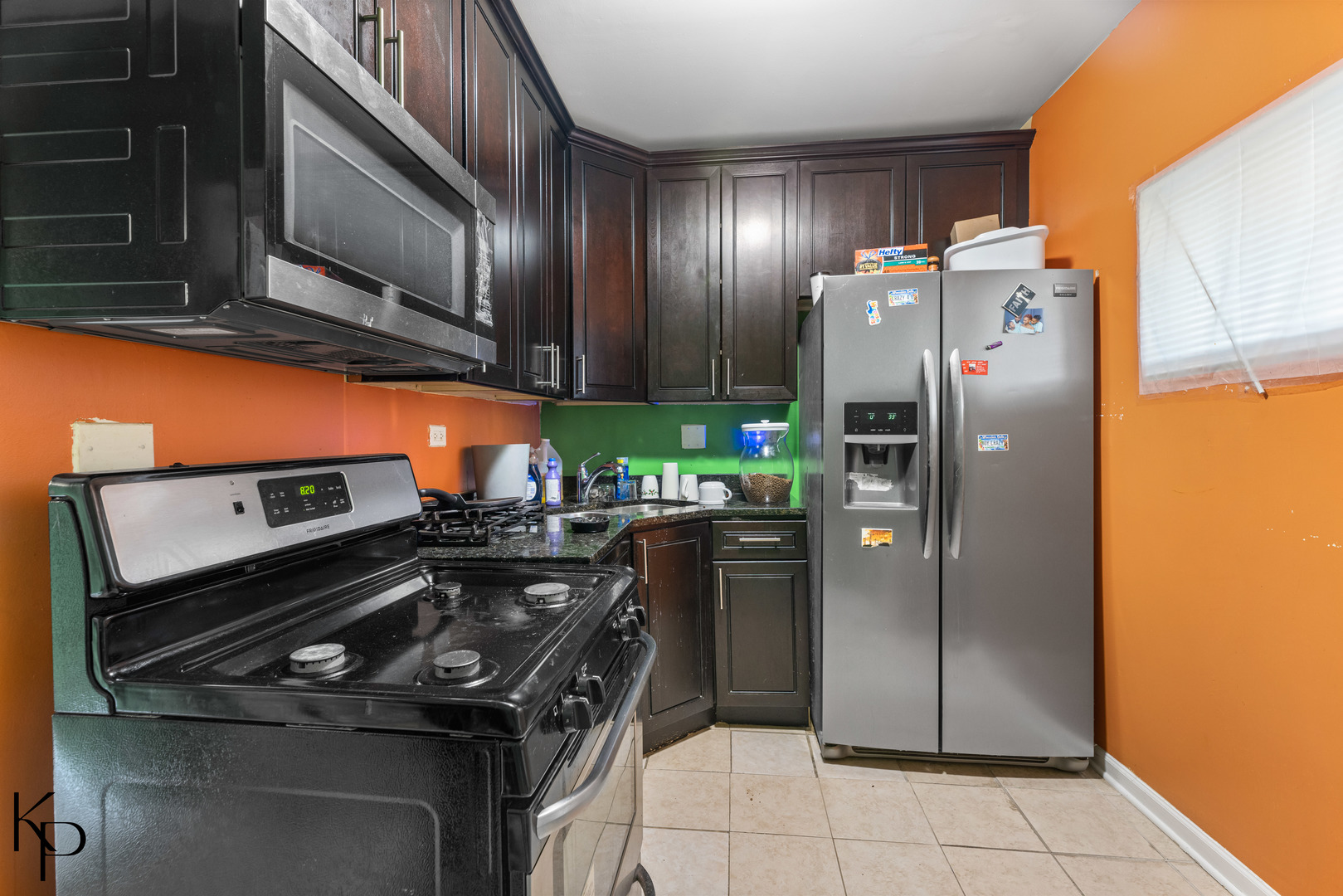 1117 West 57th Street Chicago, IL 60621 - Photo 4 of 9 a kitchen with stainless steel appliances granite countertop a refrigerator and a stove