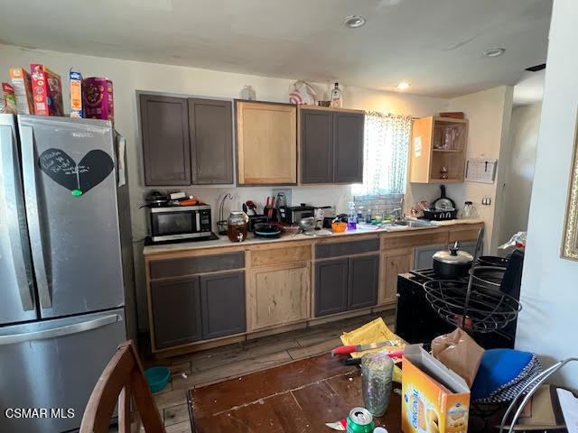 445 Millard Street Moorpark, CA 93021 - Photo 3 of 9 a kitchen with stainless steel appliances kitchen island granite countertop a refrigerator and a stove top oven
