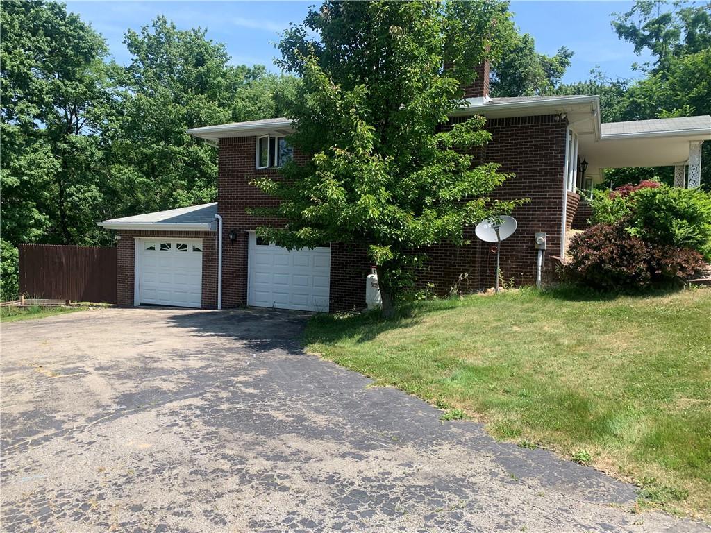 801 Beaver Road Greensburg, PA 15601 - Photo 19 of 20 a front view of a house with a yard and a garage