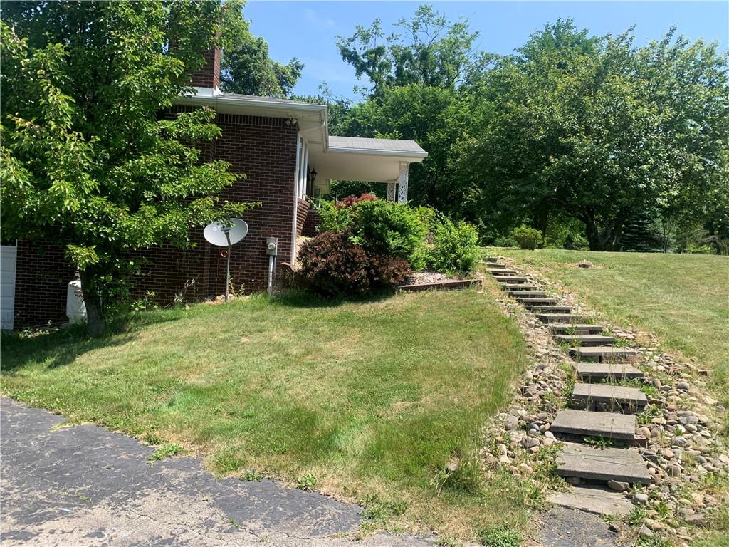 801 Beaver Road Greensburg, PA 15601 - Photo 3 of 20 a view of a backyard with table and chairs and potted plants
