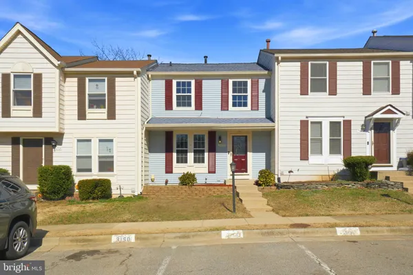 a front view of a residential apartment building with a yard