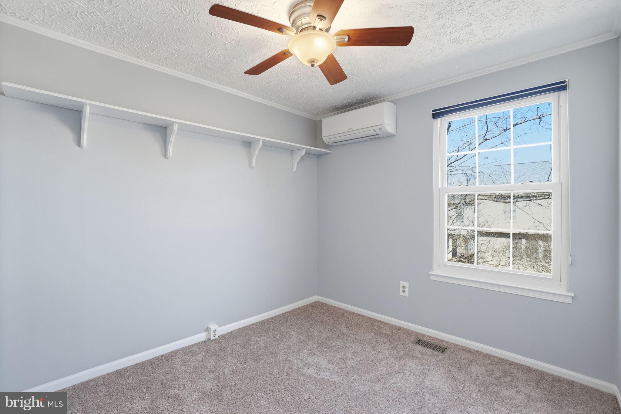 7470 Wounded Knee Road Lorton, VA 22079 - Photo 12 of 24 an empty room with a window and a fan