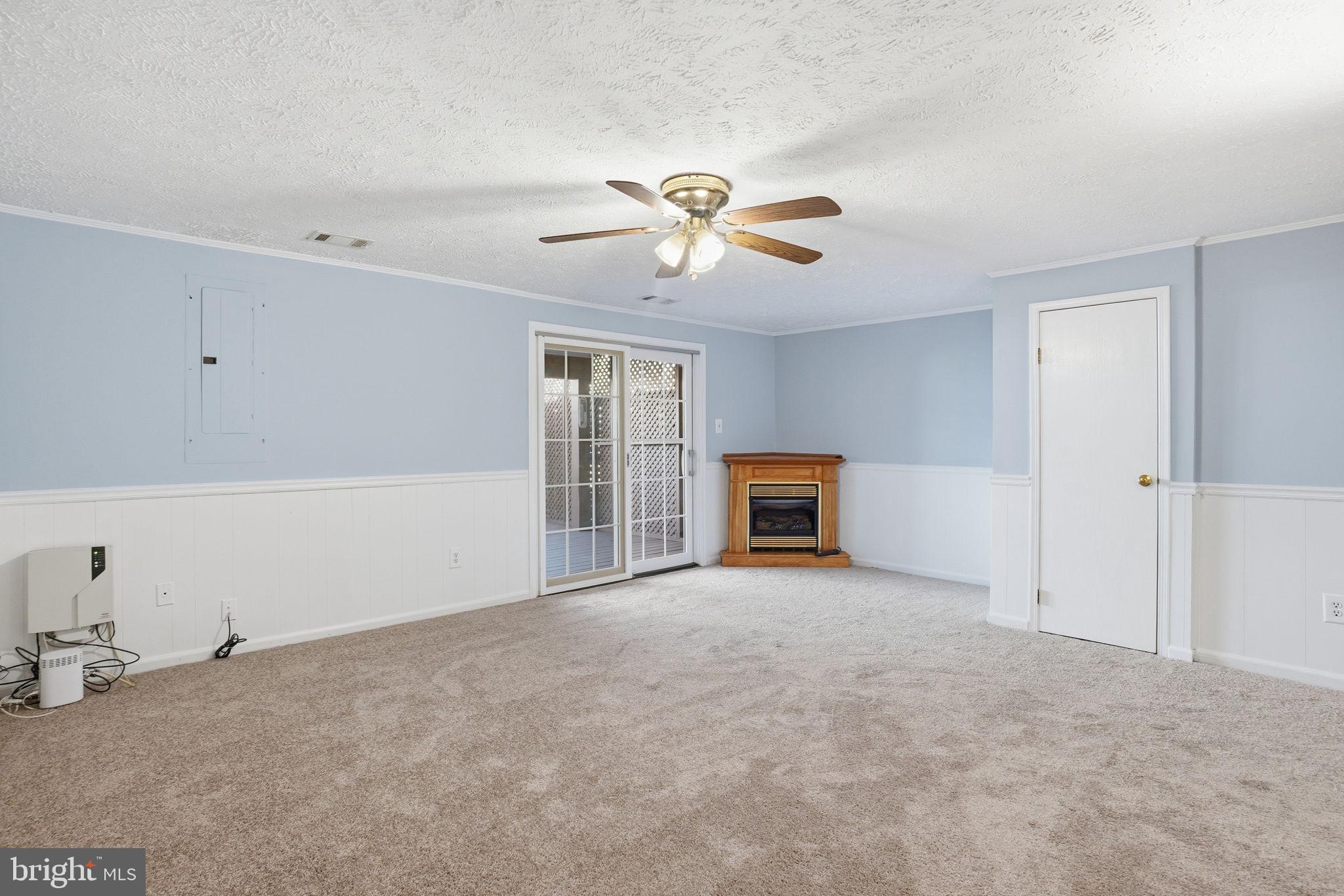 7470 Wounded Knee Road Lorton, VA 22079 - Photo 17 of 24 a view of a livingroom with a fireplace and a ceiling fan