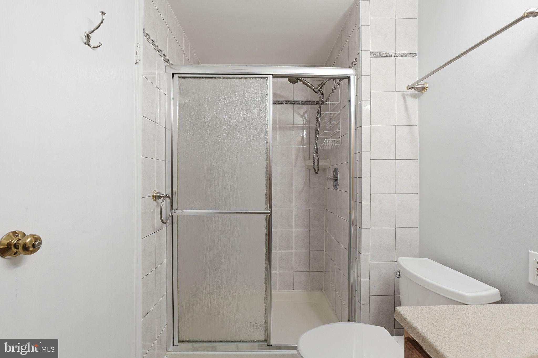 7470 Wounded Knee Road Lorton, VA 22079 - Photo 21 of 24 a bathroom with a shower and a toilet