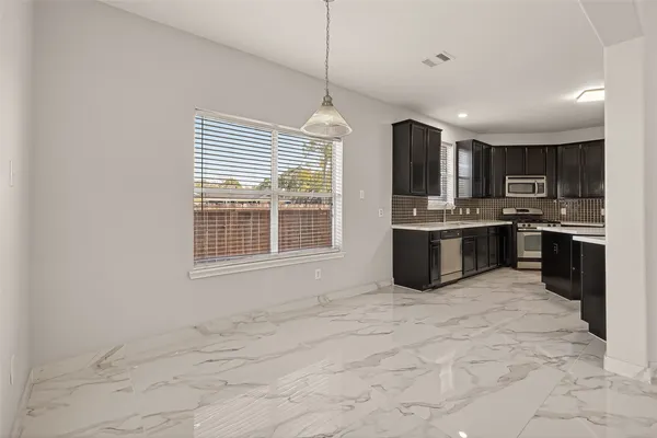 a kitchen with stainless steel appliances granite countertop a stove sink and cabinets