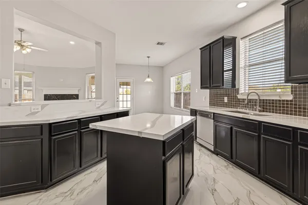 a kitchen with a sink stove and cabinets