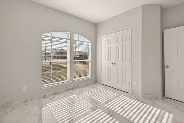 a view of a room with wooden floor and windows