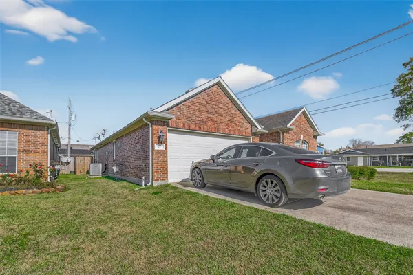 a front view of a house with cars parked