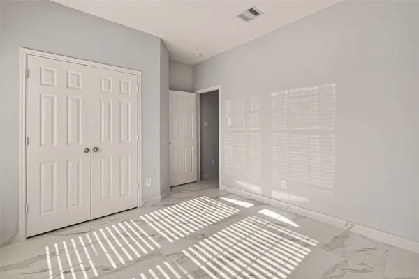 a view of a room with wooden floor and a bathroom
