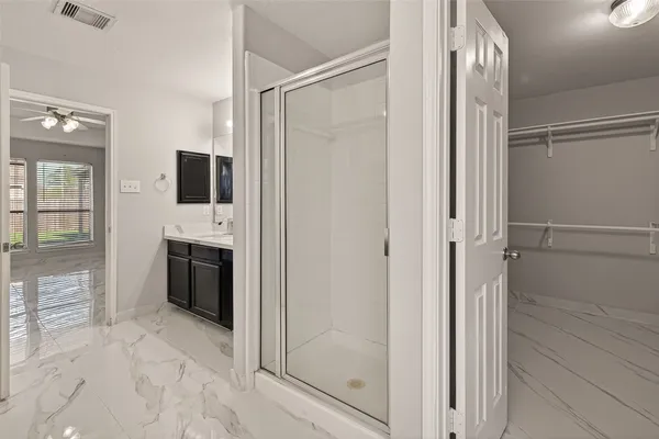 a view of a hallway with closet and a fireplace