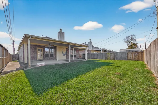 a view of a house with a backyard and porch