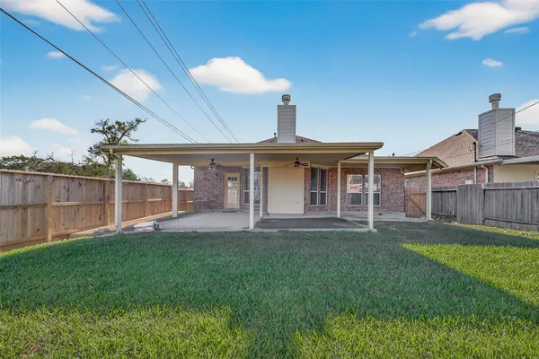 a view of a house with a yard and sitting area