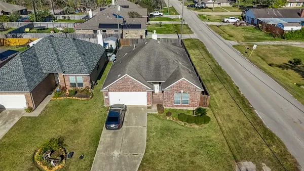 an aerial view of residential houses with outdoor space and swimming pool