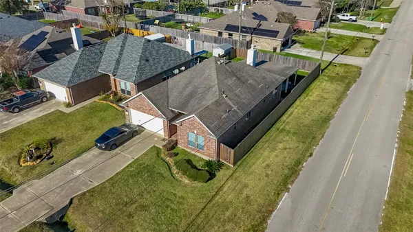an aerial view of a house with a garden and swimming pool