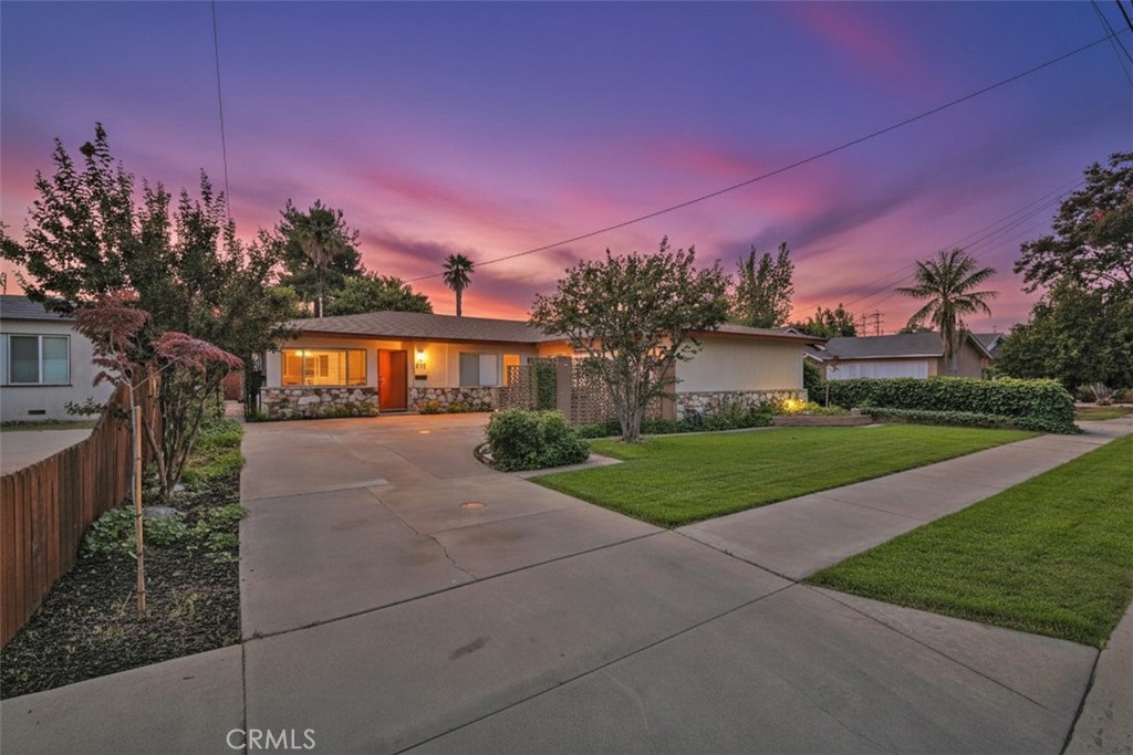a front view of a house with a yard and a garage