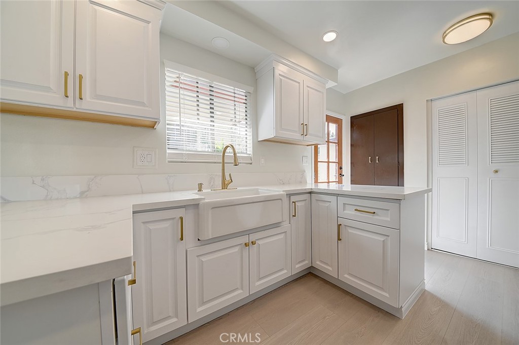 9118 Maple Street Bellflower, CA 90706 - Photo 13 of 74 a kitchen with white cabinets and a sink