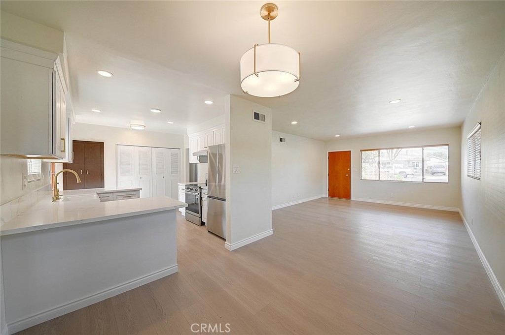 9118 Maple Street Bellflower, CA 90706 - Photo 15 of 74 a view of a kitchen with a sink and a refrigerator