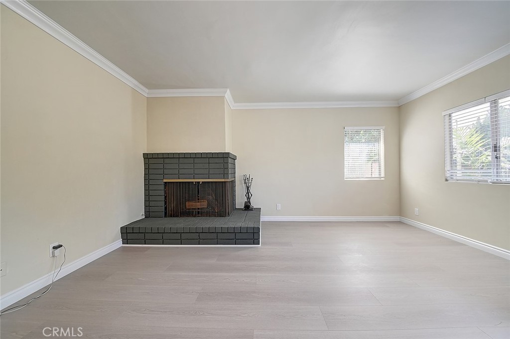 9118 Maple Street Bellflower, CA 90706 - Photo 29 of 74 a living room with a fireplace and a window