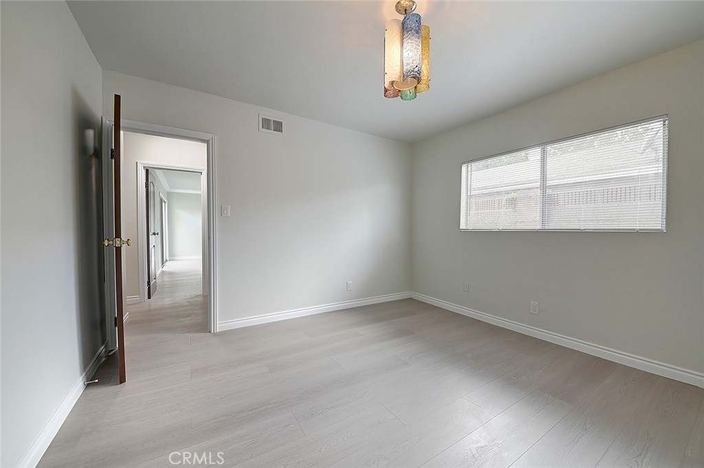 9118 Maple Street Bellflower, CA 90706 - Photo 35 of 74 an empty room with windows and chandelier