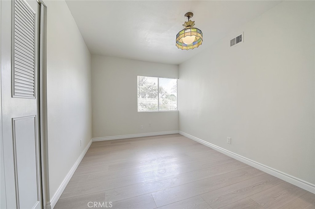 9118 Maple Street Bellflower, CA 90706 - Photo 40 of 74 an empty room with windows and fan