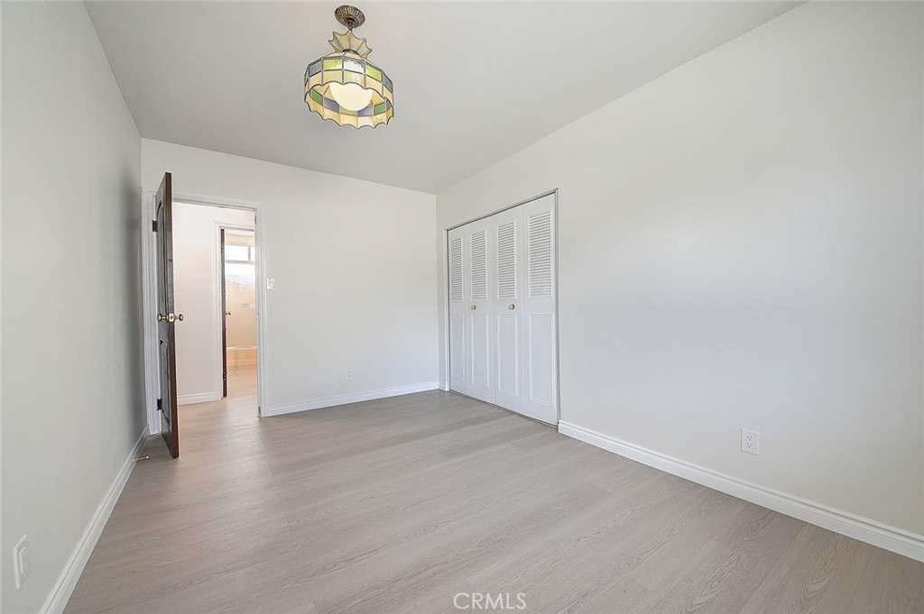 9118 Maple Street Bellflower, CA 90706 - Photo 42 of 74 a view of an empty room with wooden floor and window