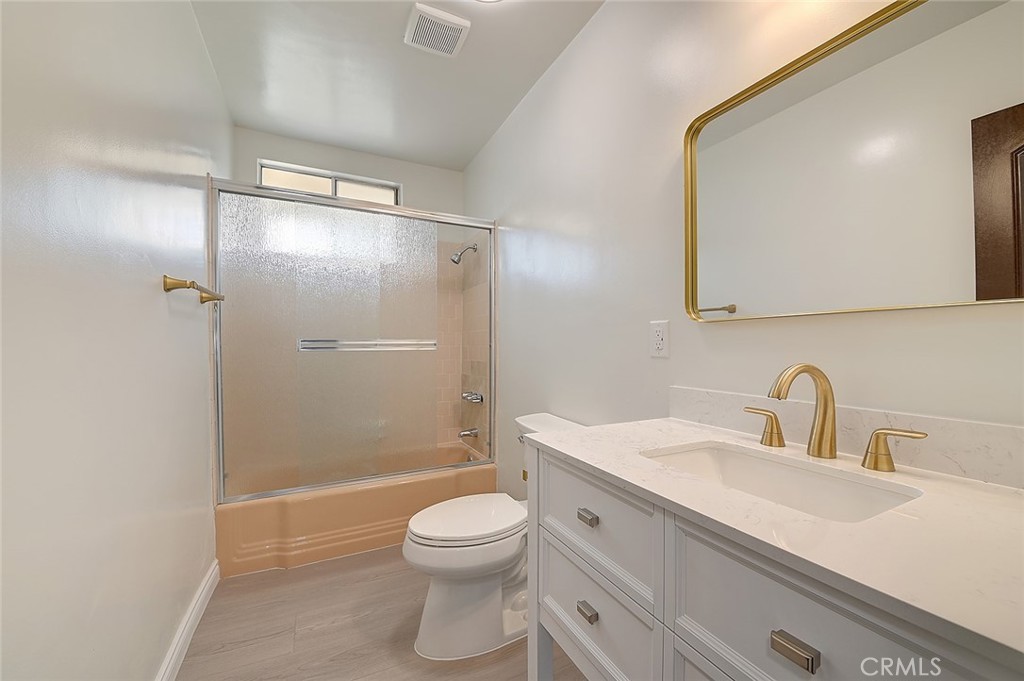 9118 Maple Street Bellflower, CA 90706 - Photo 47 of 74 a bathroom with a sink a toilet and shower