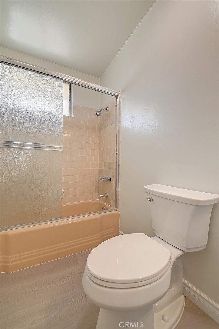 9118 Maple Street Bellflower, CA 90706 - Photo 48 of 74 a white toilet sitting next to a bath tub and a shower