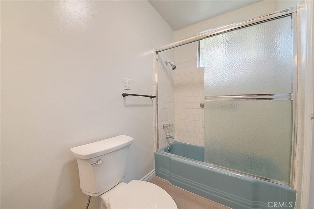 9118 Maple Street Bellflower, CA 90706 - Photo 50 of 74 a white toilet sitting next to a bath tub and shower