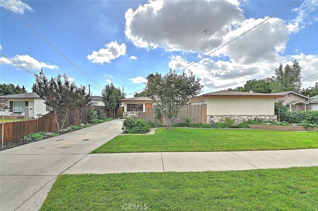 9118 Maple Street Bellflower, CA 90706 - Photo 5 of 74 a view of a house with a yard