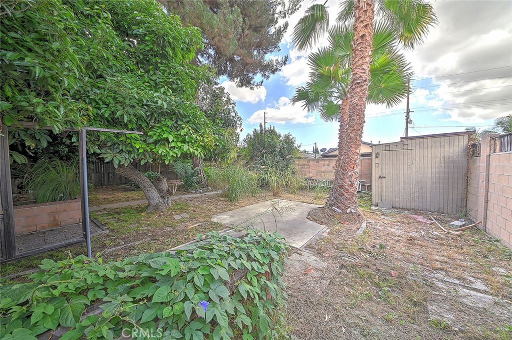 9118 Maple Street Bellflower, CA 90706 - Photo 53 of 74 a backyard of a house with lots of green space
