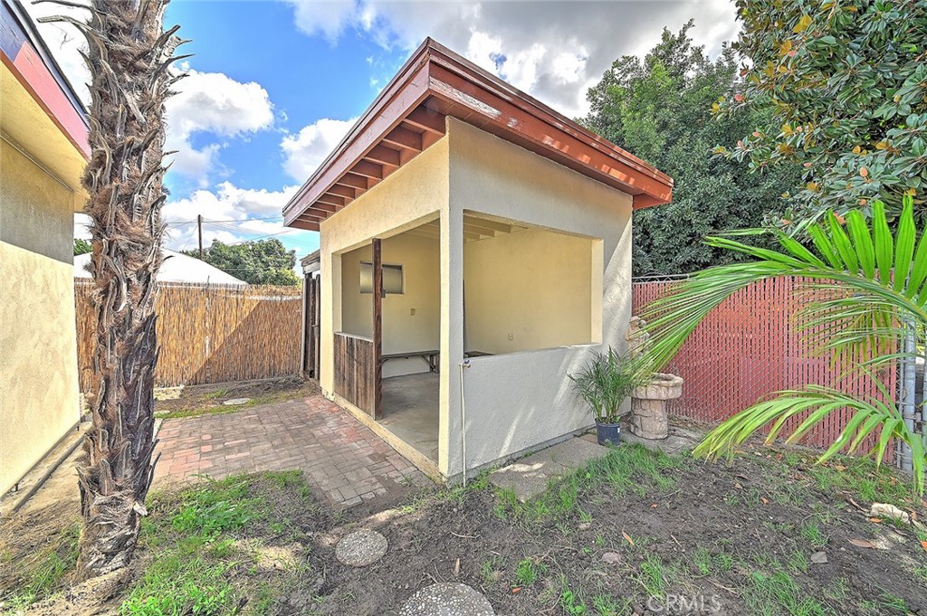 9118 Maple Street Bellflower, CA 90706 - Photo 60 of 74 a view of backyard with plants and a large tree