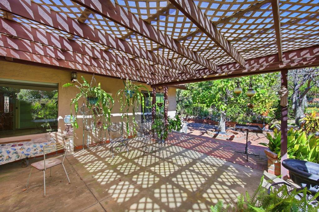2807 South Grade Road Alpine, CA 91901 - Photo 30 of 42 a view of a patio with table and chairs potted plants with wooden floor and fence