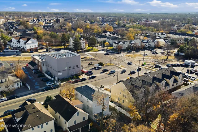 an aerial view of a houses with a swimming pool