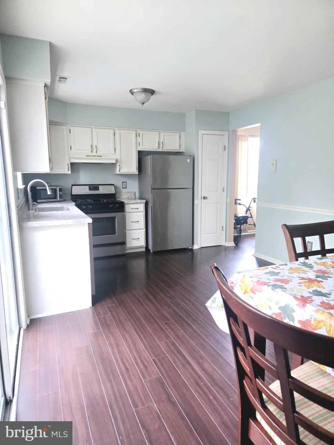 3505 Tall Pines Pine Hill, NJ 08021 - Photo 5 of 10 a kitchen with wooden floors and wooden cabinets