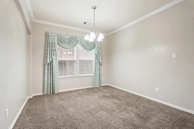 a view of a room with window chandelier fan