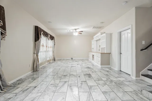 a view of a kitchen with a sink and a refrigerator