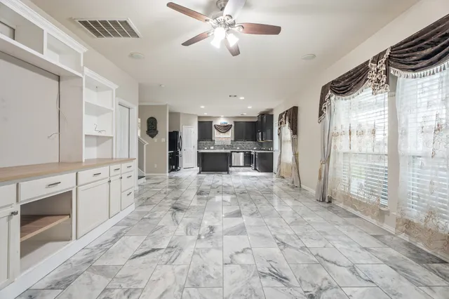 a view of a kitchen with a sink and cabinets