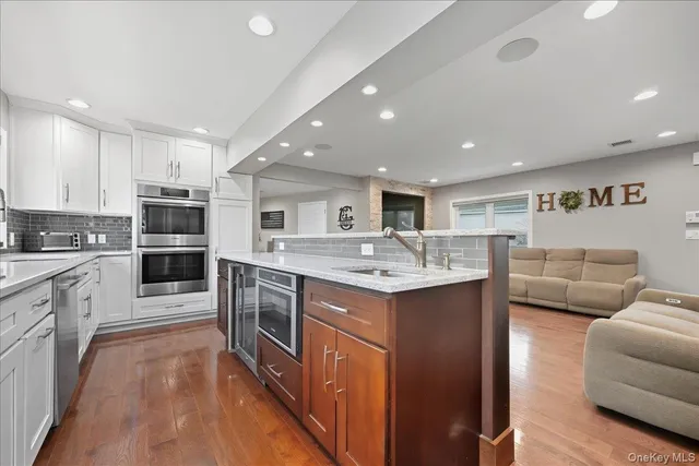 a large kitchen with stainless steel appliances kitchen island granite countertop a large counter top and stainless steel appliances