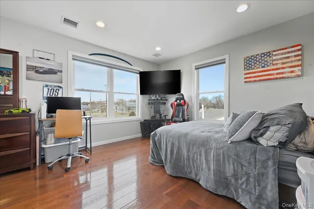 a bedroom with furniture and a flat screen tv
