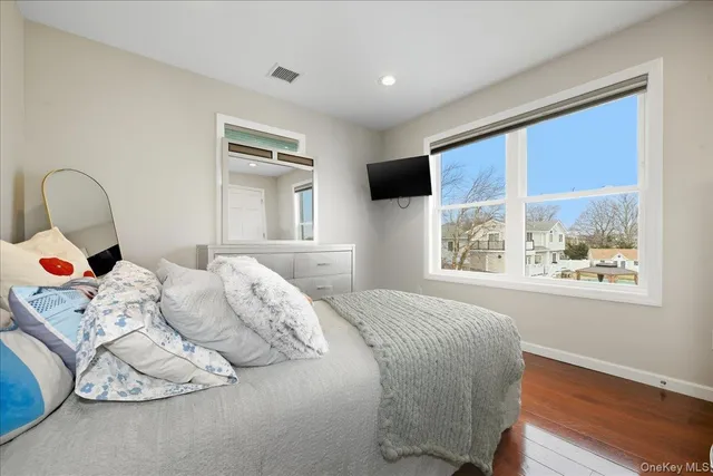 a bedroom with a bed and a large window