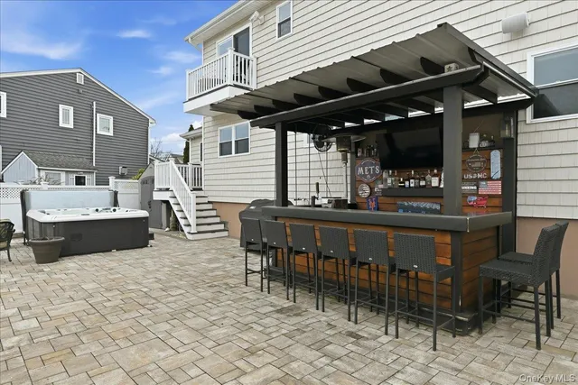 a view of a patio with table and chairs with wooden floor and fence
