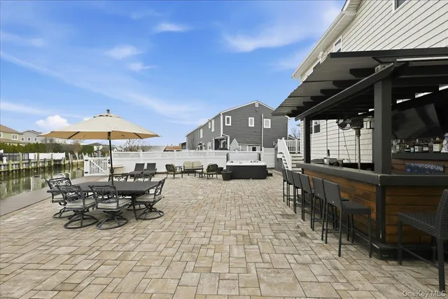 a view of a patio with table and chairs under an umbrella
