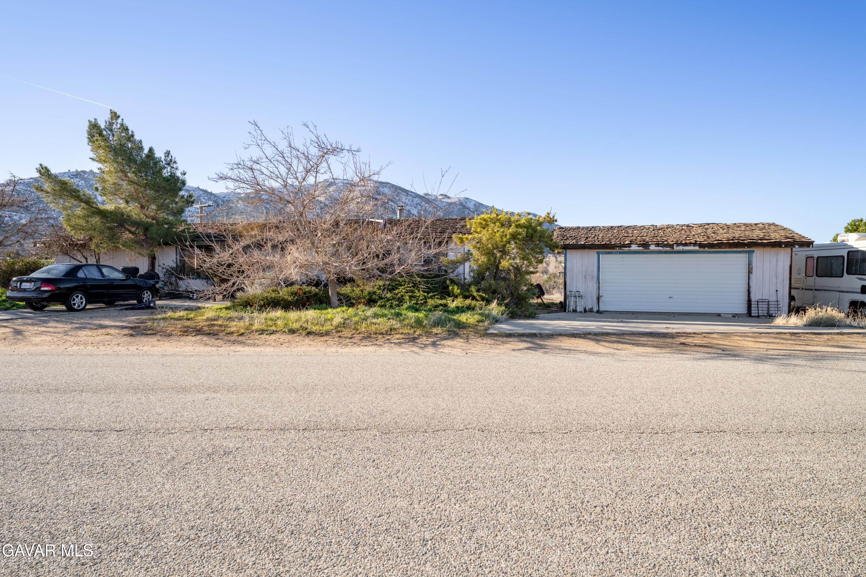 20625 Ridgecrest Drive Tehachapi, CA 93561 - Photo 1 of 2 a front view of a house with a yard and garage