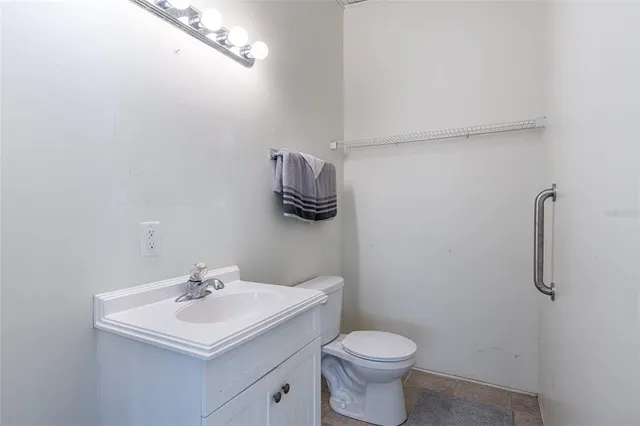 a bathroom with a sink toilet and mirror