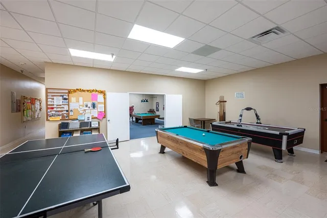 a living room with pool table and flat screen tv