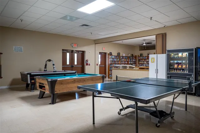 a room with furniture pool table and window