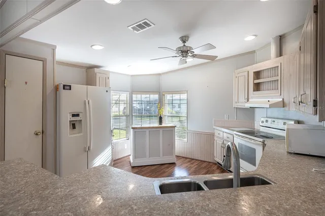 a living room with stainless steel appliances kitchen island granite countertop furniture and a kitchen view