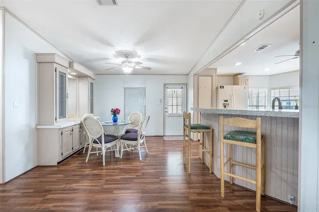 a dining room with furniture and wooden floor